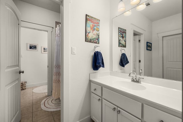 bathroom with tile patterned flooring and vanity