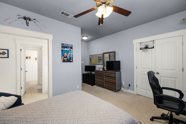 bedroom featuring ceiling fan, light colored carpet, and a closet