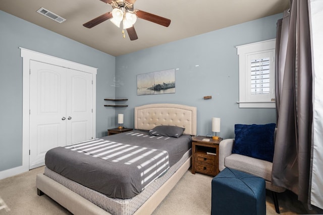 carpeted bedroom with a closet and ceiling fan