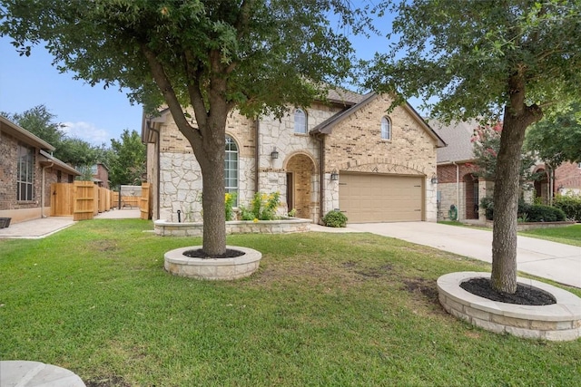 view of front of home featuring fence, driveway, a front lawn, stone siding, and brick siding