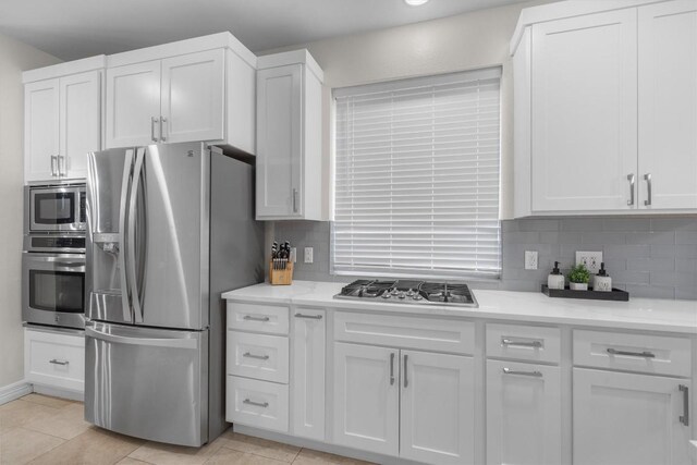 kitchen featuring white cabinetry, backsplash, and appliances with stainless steel finishes