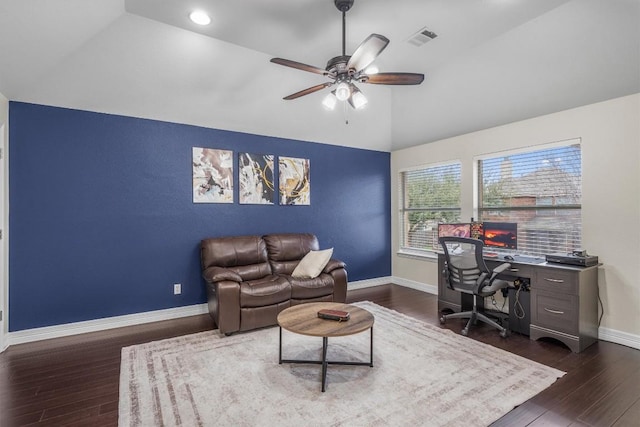 office space featuring visible vents, ceiling fan, baseboards, vaulted ceiling, and dark wood-style floors