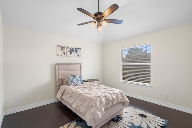 bedroom with vaulted ceiling, a ceiling fan, baseboards, and wood finished floors