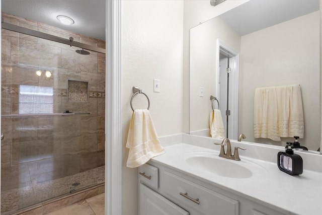 bathroom with vanity and a shower with shower door