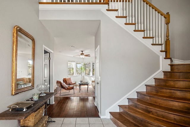 stairway with tile patterned flooring and ceiling fan