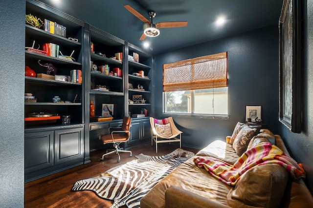 sitting room featuring ceiling fan, dark hardwood / wood-style flooring, and built in desk