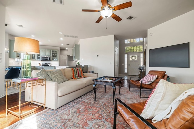 living room with light hardwood / wood-style floors and ceiling fan