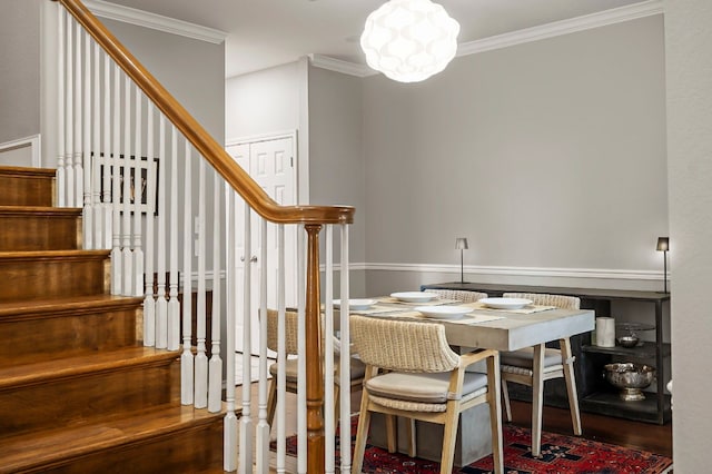 dining area with hardwood / wood-style flooring and ornamental molding