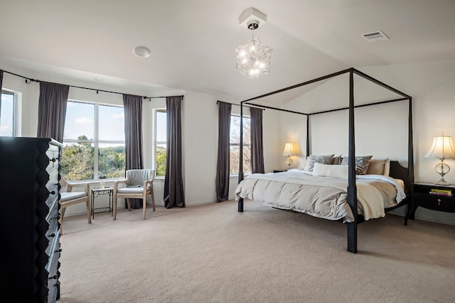 bedroom featuring multiple windows, a chandelier, vaulted ceiling, and light carpet