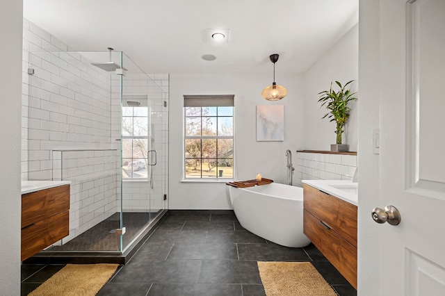 bathroom with tile patterned flooring, vanity, and plus walk in shower