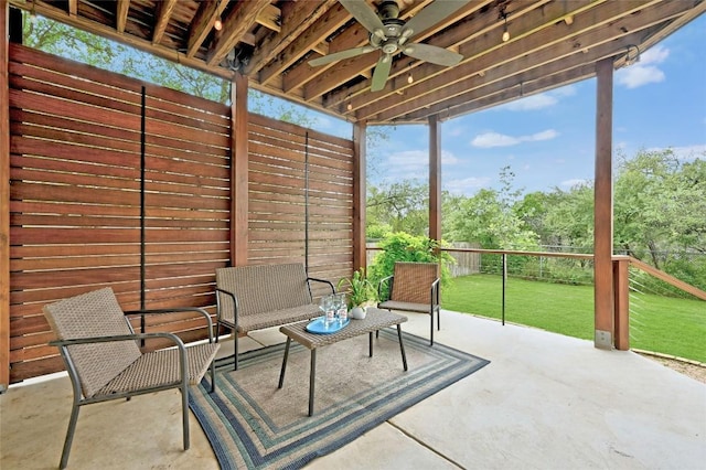 unfurnished sunroom featuring ceiling fan