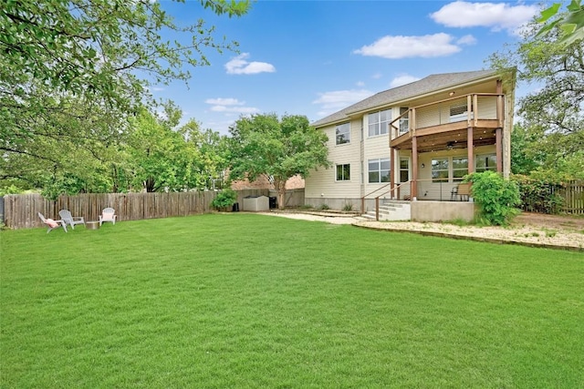 rear view of house featuring a lawn