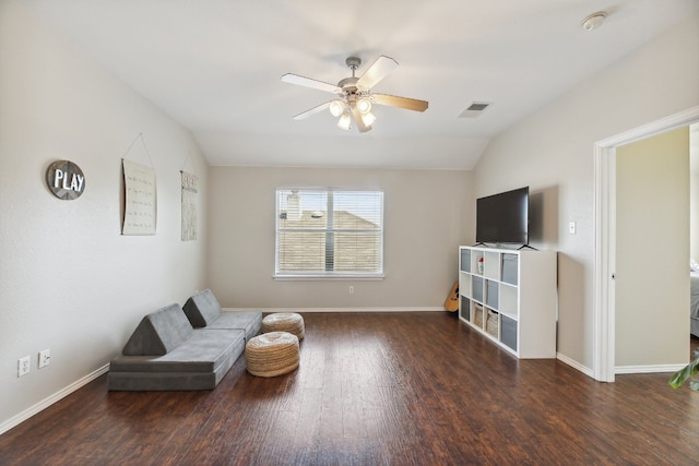 living area featuring ceiling fan, lofted ceiling, and dark hardwood / wood-style flooring