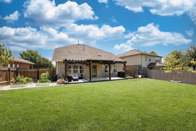 back of house featuring a lawn, a patio area, and a pergola