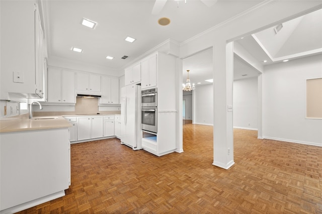 kitchen featuring white cabinetry, sink, white fridge, and light parquet floors