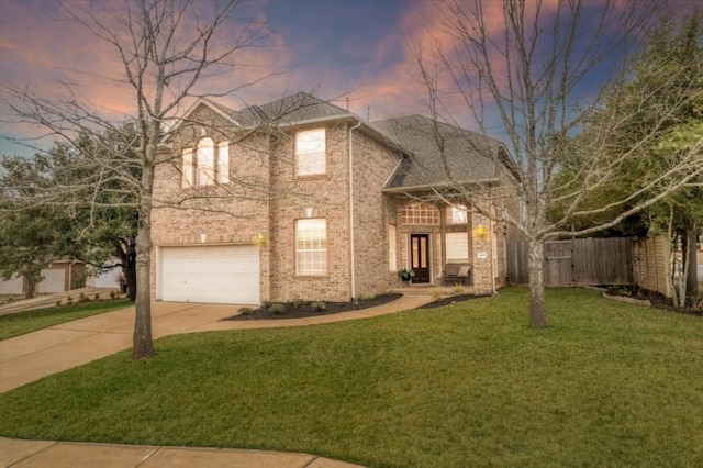 view of front of home featuring a garage and a lawn