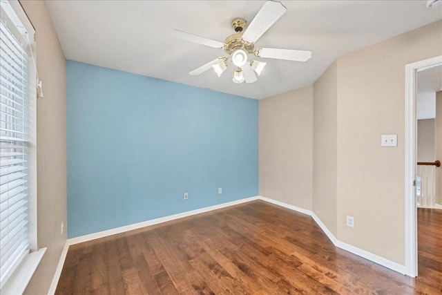 empty room with dark wood-type flooring and ceiling fan