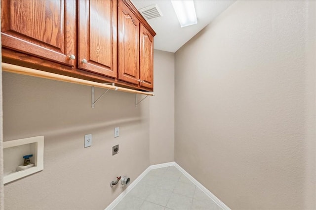 washroom with cabinets, hookup for a washing machine, hookup for an electric dryer, and hookup for a gas dryer