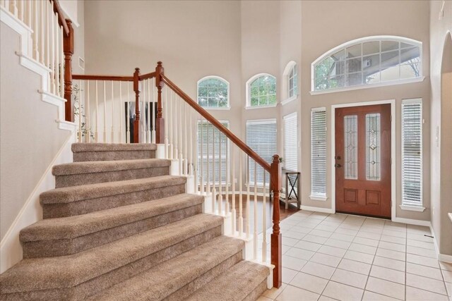 tiled entryway with a high ceiling