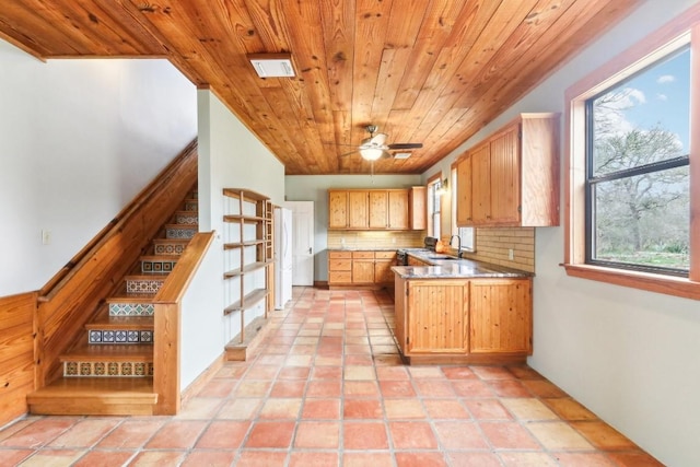 kitchen featuring sink, ceiling fan, backsplash, light tile patterned flooring, and wooden ceiling