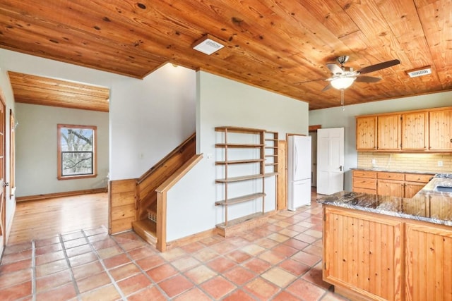 kitchen with light tile patterned floors, stone counters, tasteful backsplash, wooden ceiling, and white fridge