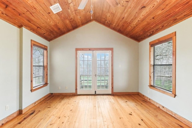 unfurnished room with lofted ceiling, light hardwood / wood-style floors, and a wealth of natural light