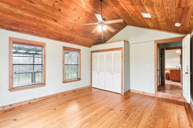 unfurnished bedroom featuring a closet, lofted ceiling, light hardwood / wood-style flooring, and wooden ceiling