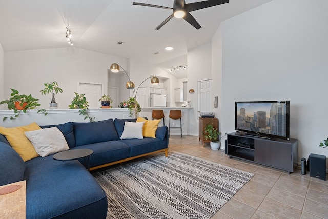 7009 Marejada Dr, Austin, TX 78724 - living area with lofted ceiling, light tile patterned floors, rail lighting, ceiling fan, and baseboards