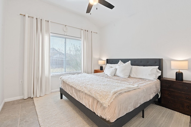 tiled bedroom featuring ceiling fan and lofted ceiling