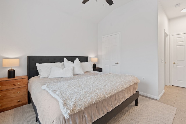 bedroom featuring vaulted ceiling, tile patterned floors, and ceiling fan