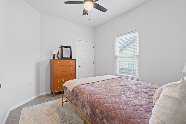 bedroom with a ceiling fan and baseboards