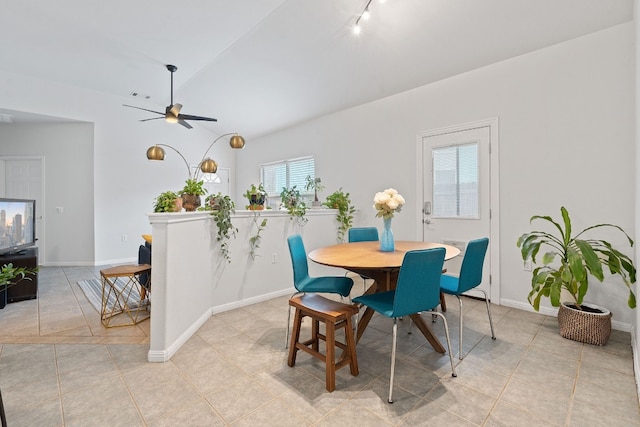 dining space featuring light tile patterned floors, ceiling fan, visible vents, baseboards, and vaulted ceiling