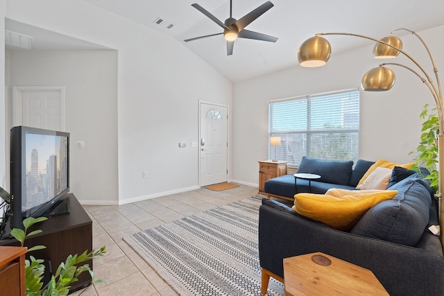 living room featuring lofted ceiling, light tile patterned floors, and ceiling fan