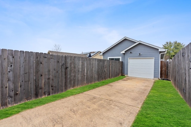 exterior space with concrete driveway and fence