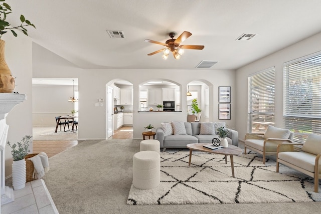 living room with light carpet and ceiling fan