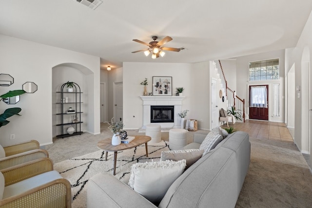 living room featuring light colored carpet and ceiling fan