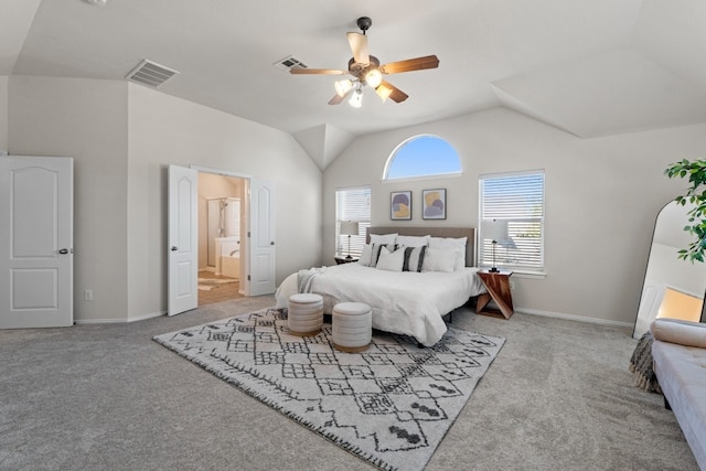 bedroom with lofted ceiling, light carpet, connected bathroom, and ceiling fan