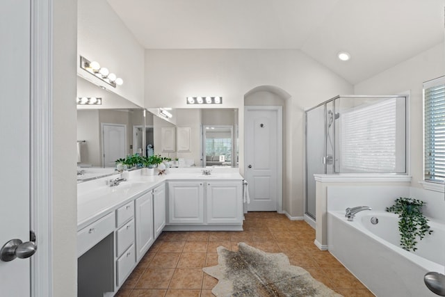 bathroom featuring vaulted ceiling, shower with separate bathtub, and tile patterned flooring