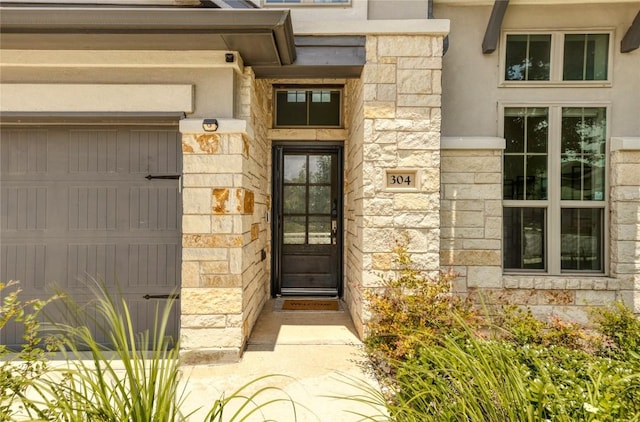 view of exterior entry featuring a garage