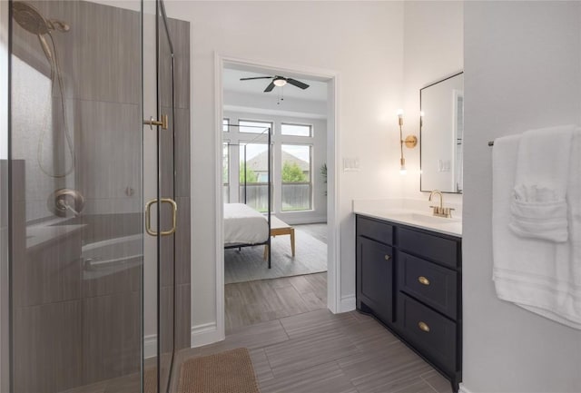 bathroom featuring vanity, ceiling fan, and walk in shower