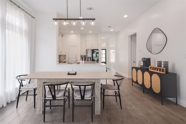 dining space featuring dark hardwood / wood-style floors