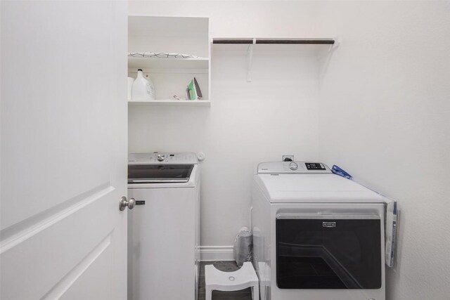 clothes washing area with washing machine and dryer