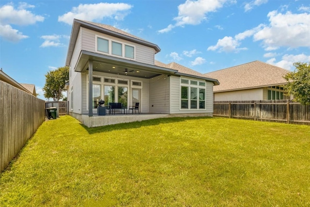 back of property featuring a lawn, a patio, and ceiling fan