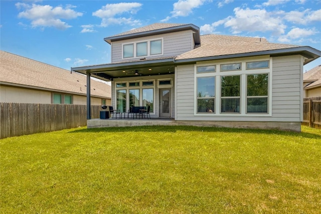 back of house with ceiling fan, a yard, and a patio