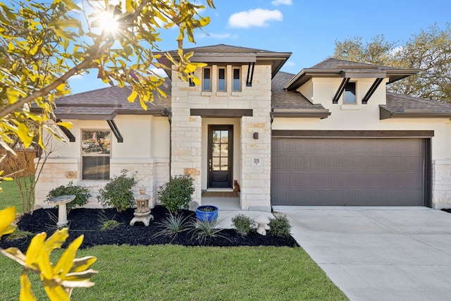 view of front of house with a garage and a front yard