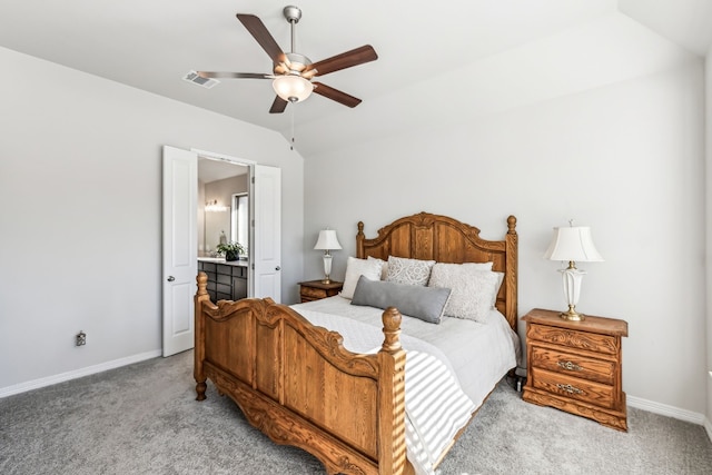 bedroom featuring lofted ceiling, connected bathroom, light colored carpet, and ceiling fan