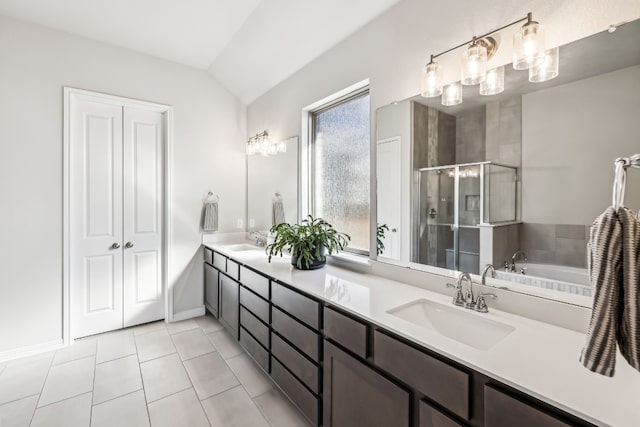 bathroom featuring vanity, tile patterned flooring, vaulted ceiling, and separate shower and tub