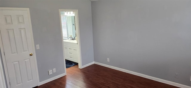 unfurnished bedroom with dark hardwood / wood-style flooring