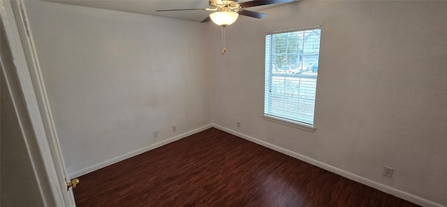 spare room featuring dark wood-type flooring and ceiling fan