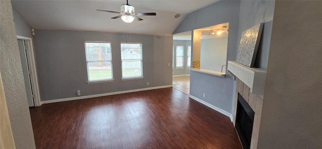 unfurnished living room featuring vaulted ceiling, dark hardwood / wood-style floors, and ceiling fan